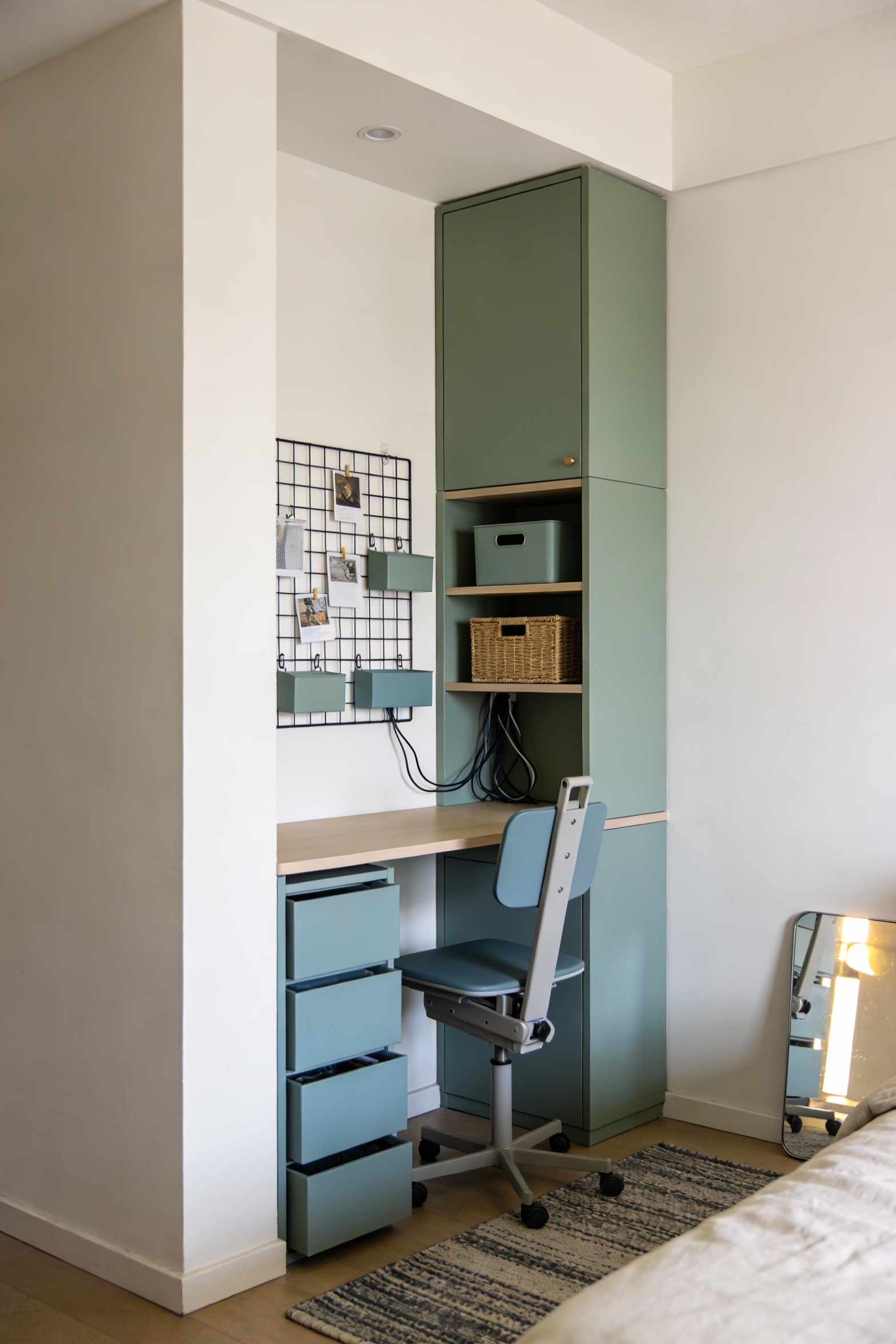 Corner-angle photorealistic small-space work nook in a bedroom/living room corner designed to feel built-in and architec